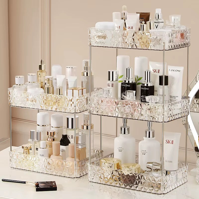 Tiered vanity makeup organizer with clear faceted acrylic and stacked open compartments