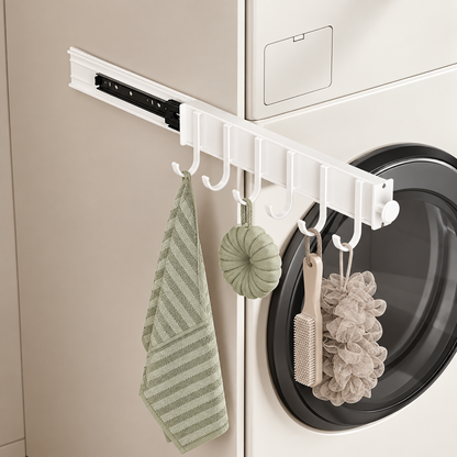 White sliding hook rail with curved hooks holding a towel and bath accessories by washer
