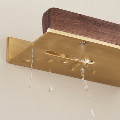 Walnut wood floating shelf with light gold base and four metal hanging hooks