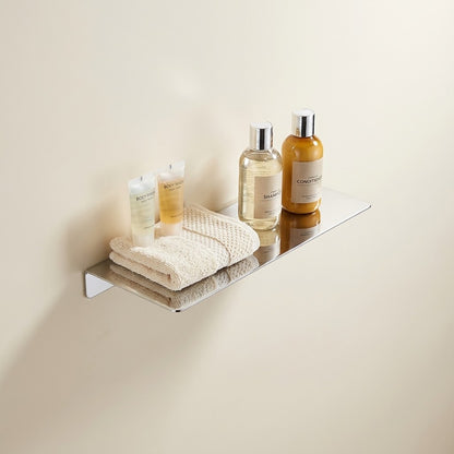 Chrome floating shelf holding towels and bottles on a minimalist rectangular ledge.