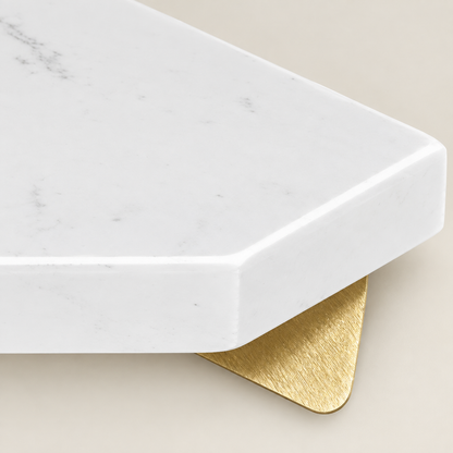 White marble shelf corner with gold mounting bracket under the overhang