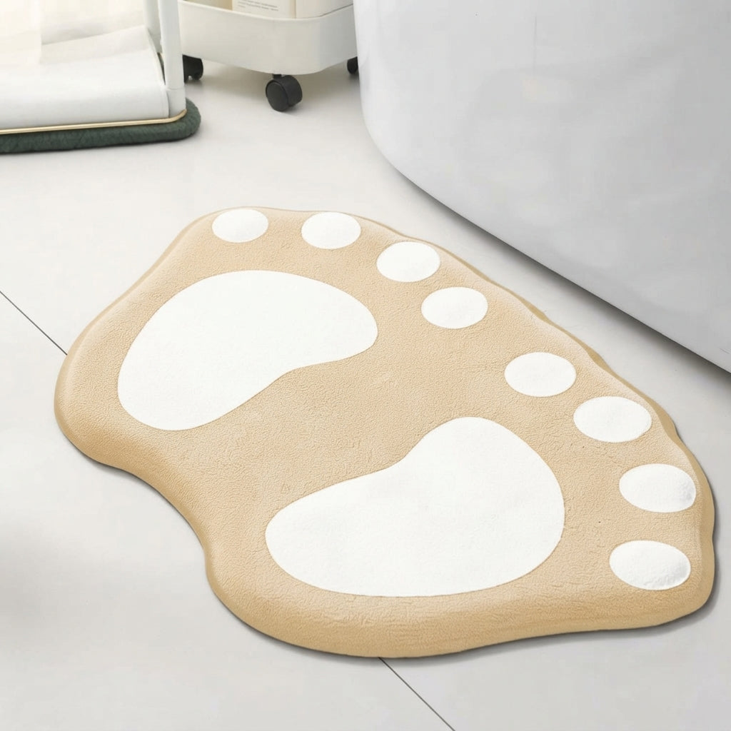 Paw-shaped bath mat in beige with white paw prints and white dot accents