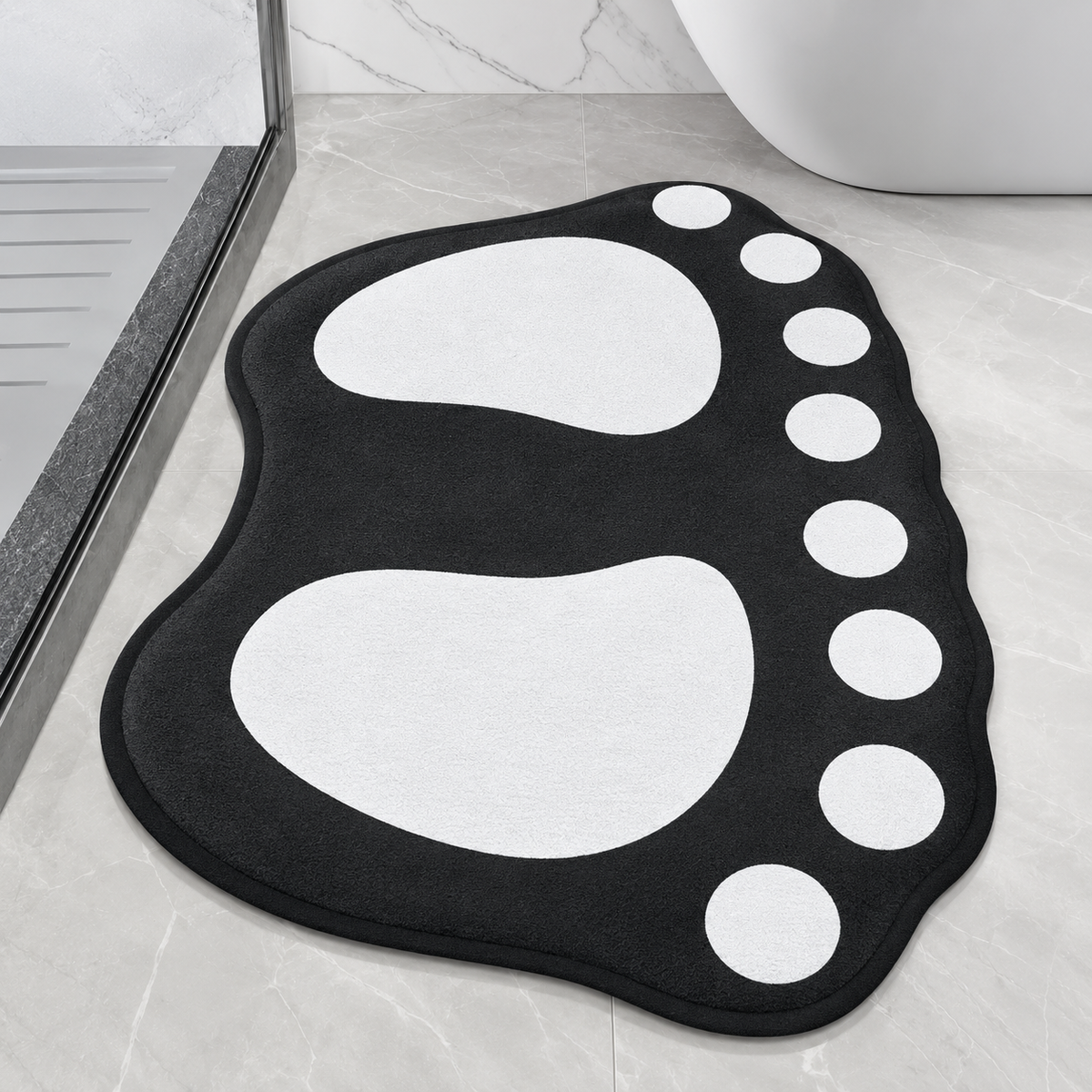 Paw-shaped bath mat in black with white paw prints and white dot accents