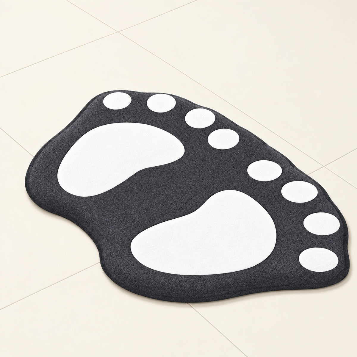Paw-shaped bath mat in dark charcoal with white paw prints and white dot accents