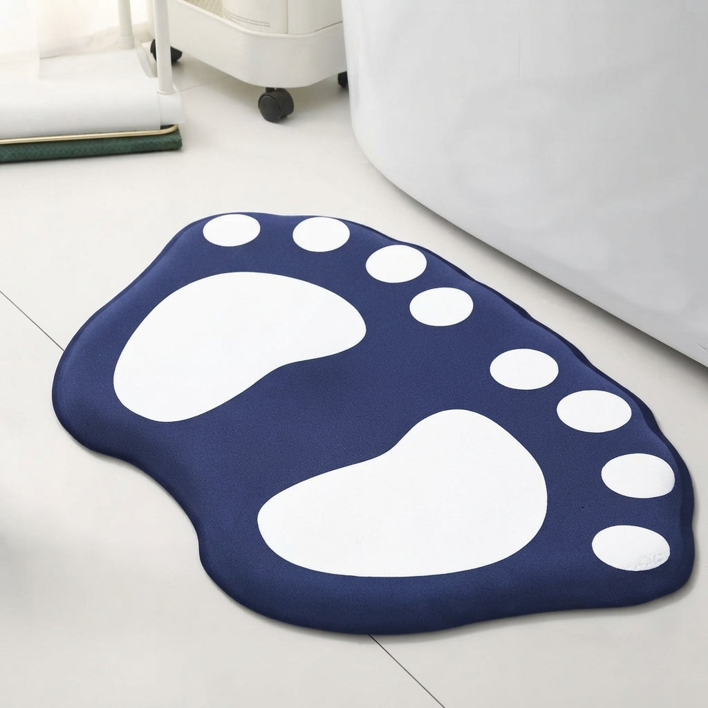 Paw-shaped bath mat in navy blue with white paw prints and white dot accents