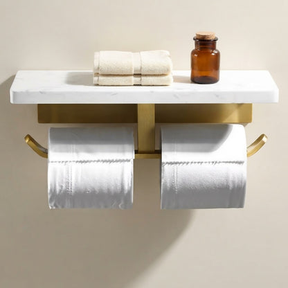 Marble-look toilet roll holder with curved brushed gold arms and shelf for towels