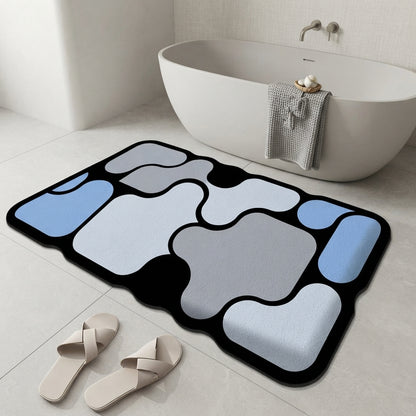 Abstract non-slip bath mat with blue and white irregular shapes on dark border