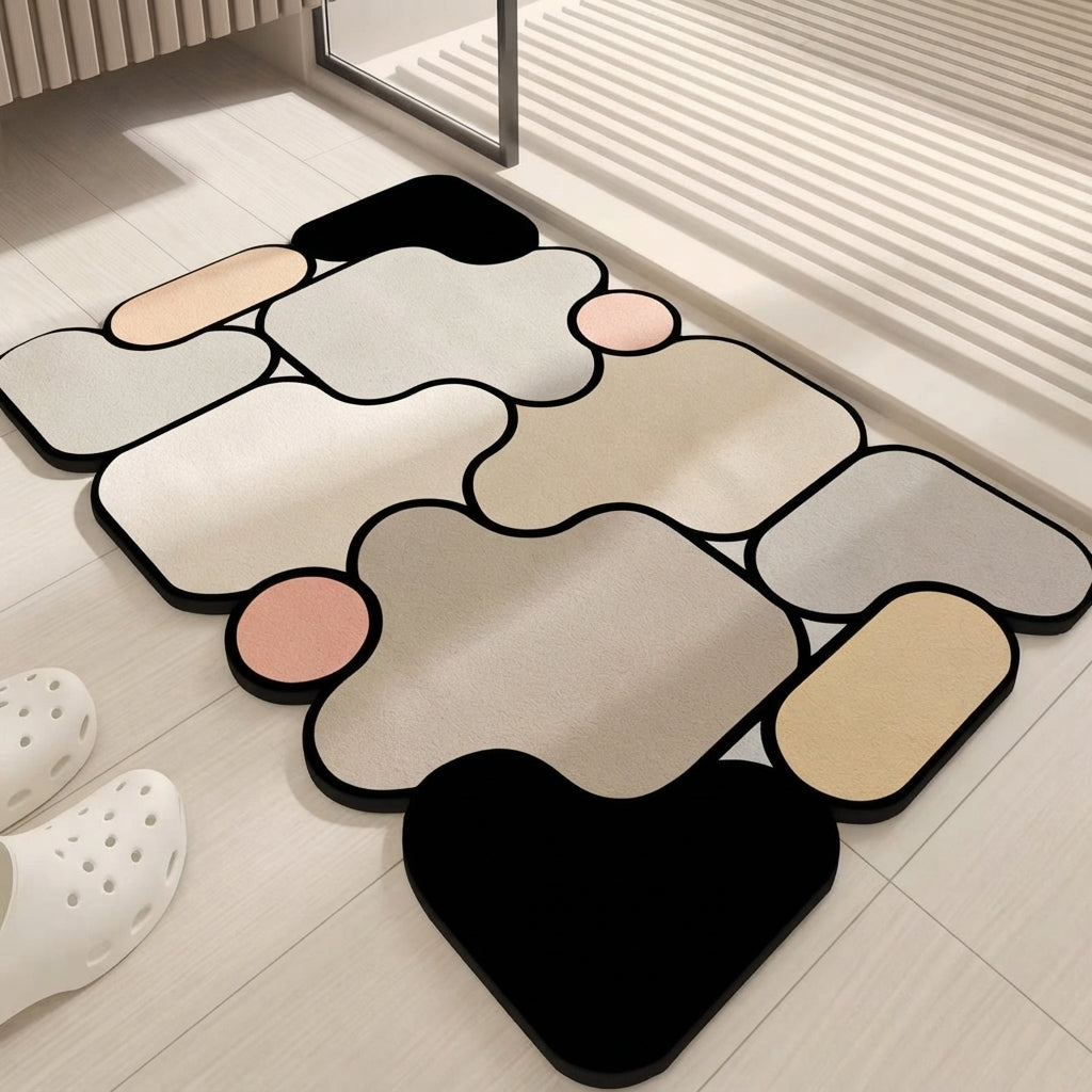 Irregular bath mat in black, beige, gray, and pink with non-slip design