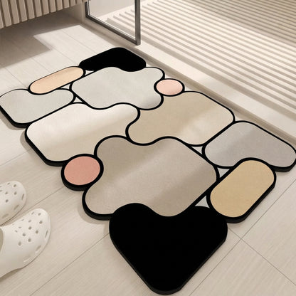 Irregular bath mat in black, beige, gray, and pink with non-slip design