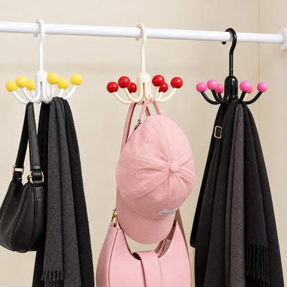 Multiple rotating claw hangers with yellow, red, pink, and black ball tips