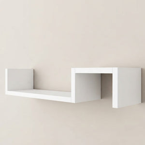 White wooden geometric wall shelf with open cubby sections