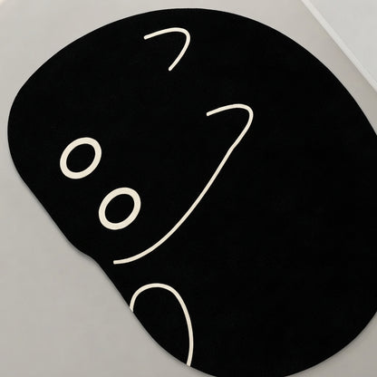 Black cat-shaped bath mat close-up of peeking face, white eyes and nose outline
