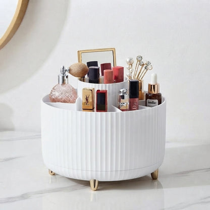 White ribbed 360 rotating makeup organizer with gold feet holding assorted cosmetics