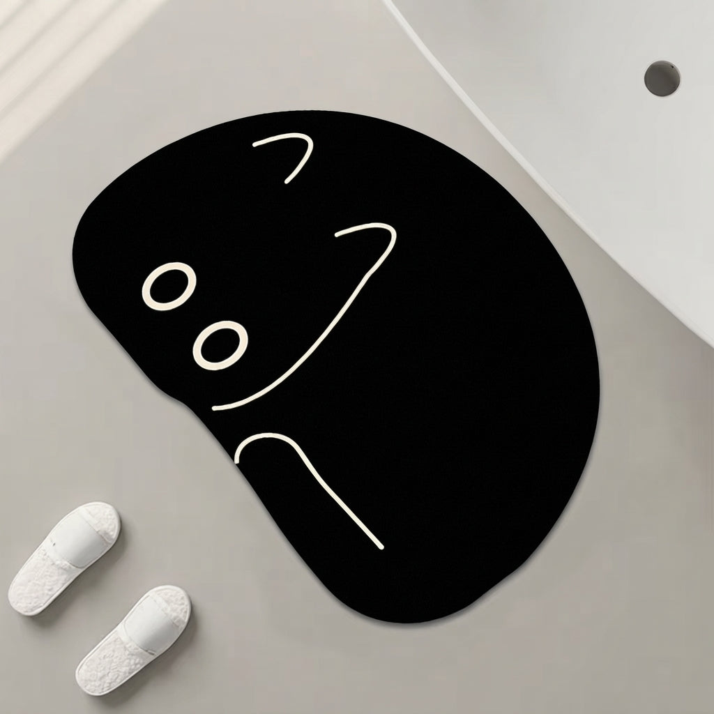 Black cat-shaped bath mat with peeking face design, white line eyes and nose