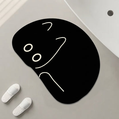 Black cat-shaped bath mat with peeking face design, white line eyes and nose