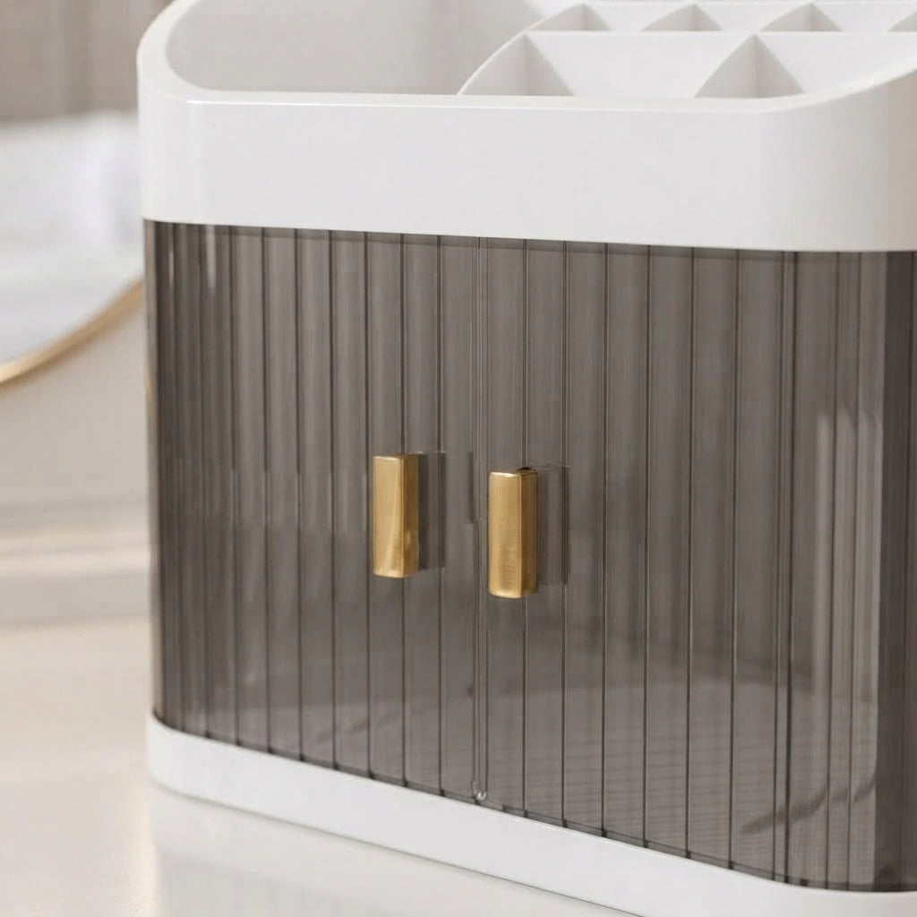 Countertop makeup organizer with gray ribbed sides and gold handle accents