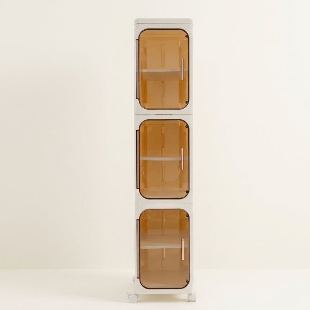Slim rolling bathroom storage cabinet with three amber-tinted doors and clear shelves
