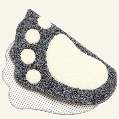 Dark gray shaggy microfiber bath mat with white footprint and paw spots, non-slip backing