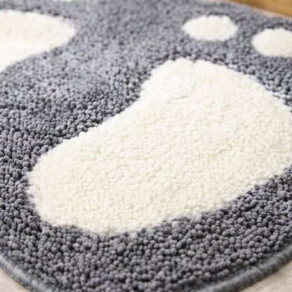 Close-up of shaggy microfiber bath mat with dark gray pile and white footprint patch