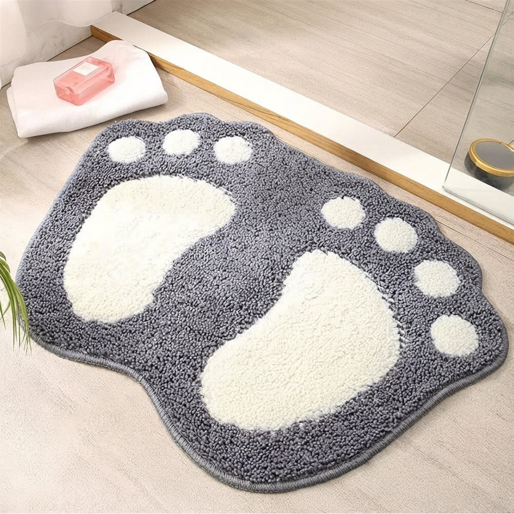 Footprint bath mat in dark gray shaggy microfiber with three white prints and paw dots