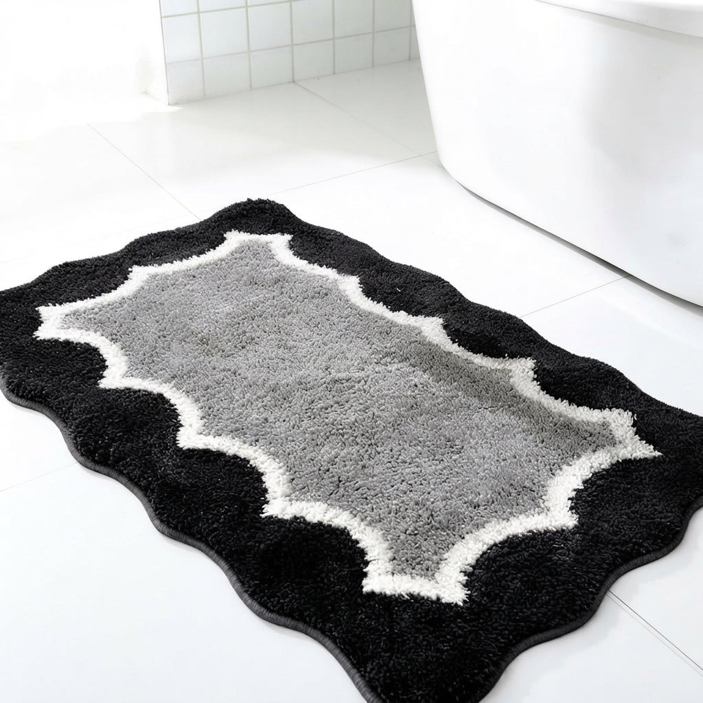 Scalloped microfibre non-slip bath mat in black with light grey quatrefoil pattern