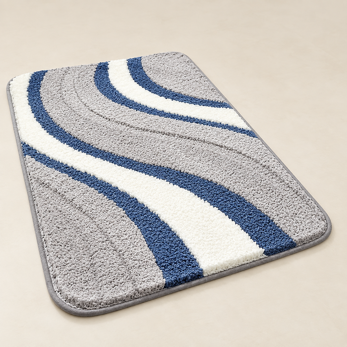 Tufted wave stripe bath mat with gray and blue loops plus white stripe, non-slip backing.