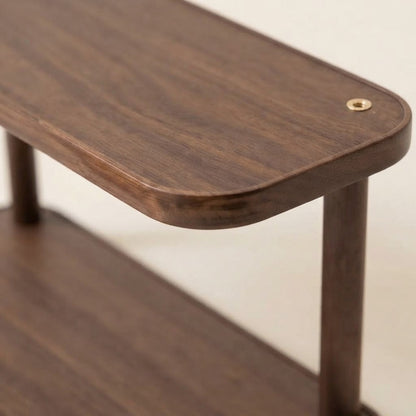 Close-up corner of two-tier bamboo rack with brass-toned grommet detail