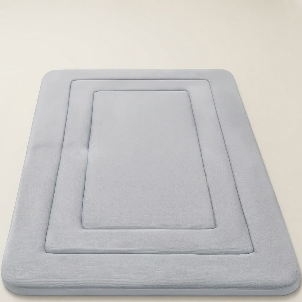 Light grey soft cushioned non-slip bath mat with recessed square design