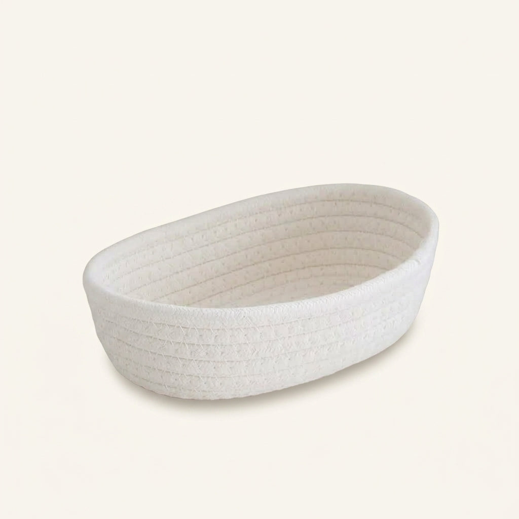 Ivory woven cotton rope oval storage basket with textured ribbed weave, open top