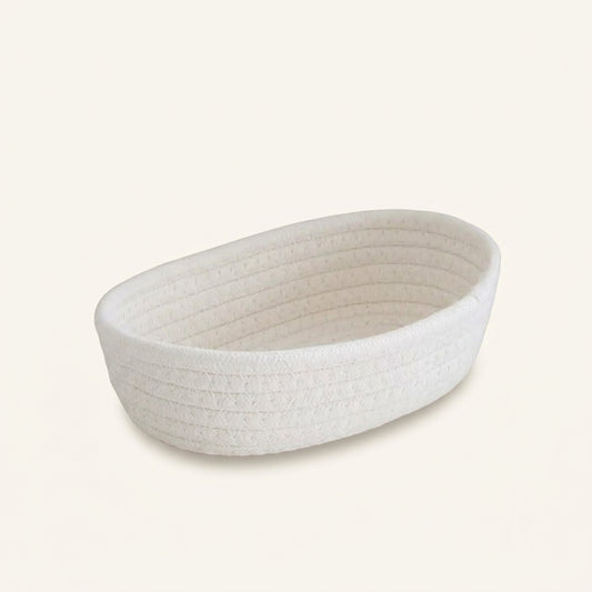 Ivory woven cotton rope oval storage basket with textured ribbed weave, open top