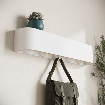 Wall-mounted concealed hook rail with white wood front and hidden hook slots