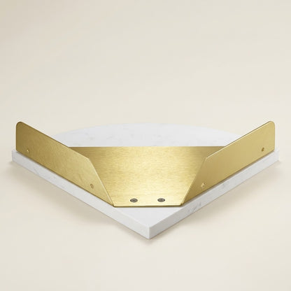 White marble corner shelf with gold supports and rounded front, close-up angle
