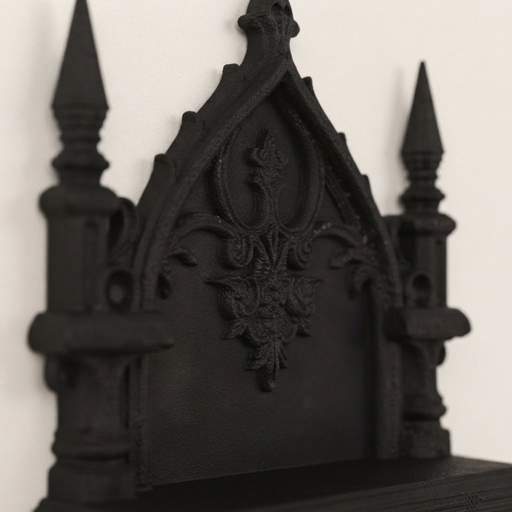 Two-tier gothic wall shelf with ornate central crest, dark finish, sculpted details