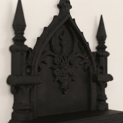 Two-tier gothic wall shelf with ornate central crest, dark finish, sculpted details