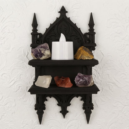 Two-tier gothic wall shelf with arched crest, candle and assorted gemstones