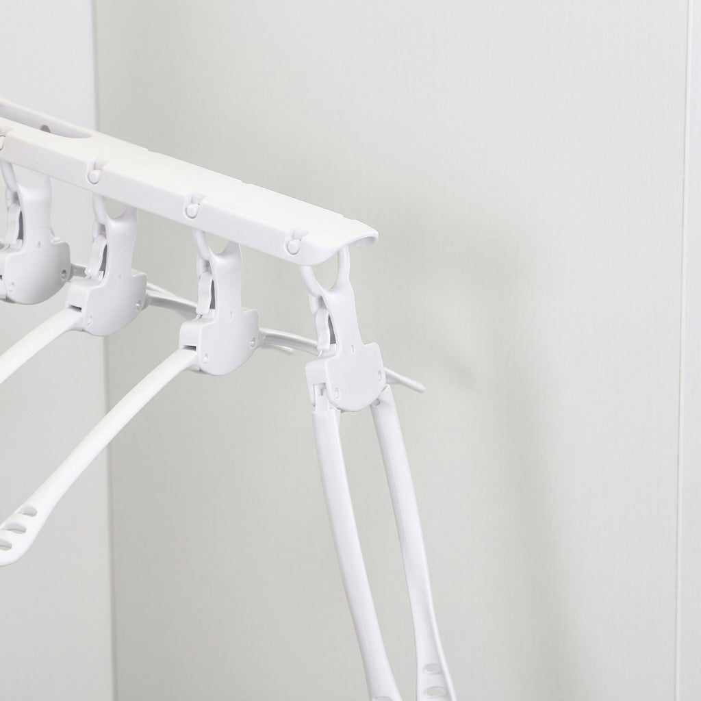 White folding arms of multi-arm clothes hanger with clip grips