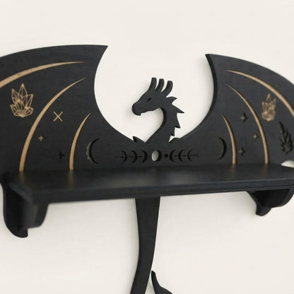 Black wooden wall shelf with dragon head figure and gold arc detailing.