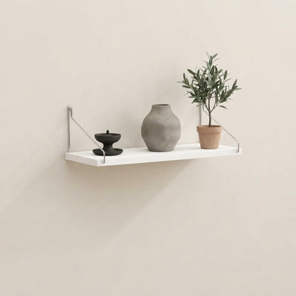 Bracket-mounted floating wall shelf with white shelf, metal brackets, and raised guard edges