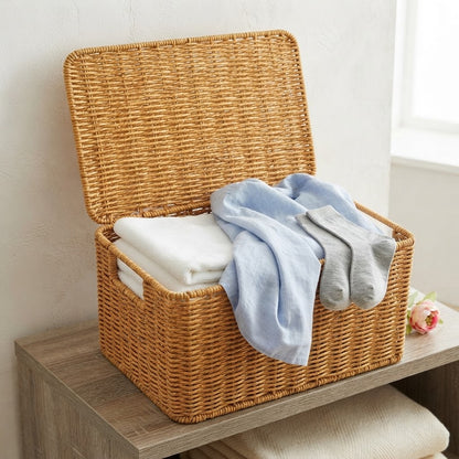 Woven rattan storage chest with lid, open top with folded blankets inside