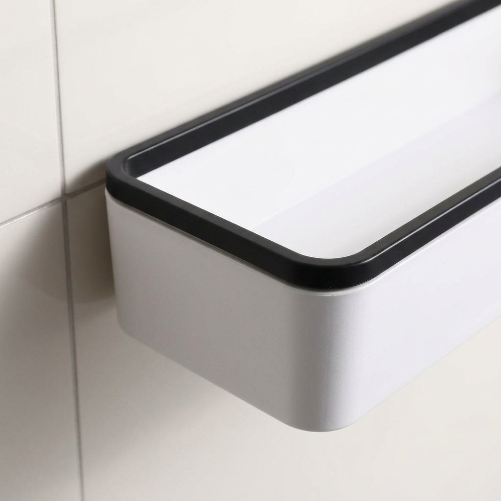 Wall-mounted bathroom storage shelf corner detail with white body and black trim