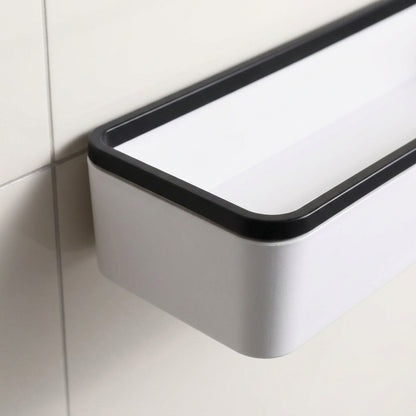 Wall-mounted bathroom storage shelf corner detail with white body and black trim