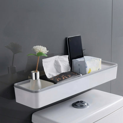Wall-mounted bathroom storage shelf with white body and black trim, holding toiletries