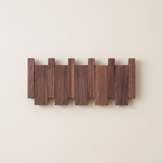 Wall-mounted solid wood coat rack with dark walnut flip-down hooks