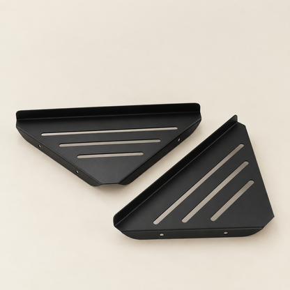 Two black stainless steel slatted corner shelves, each with three bar openings.