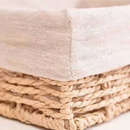 Close-up of beige fabric liner corner on woven willow straw storage basket