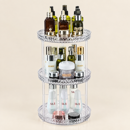 Three-tier rotating makeup organizer with clear tiers and mirrored diamond-pattern base