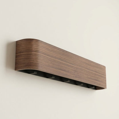 Wall-mounted concealed hook rail with walnut wood front and hidden black hook slots