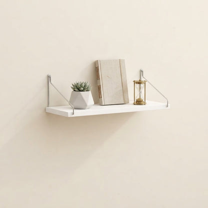 Bracket-mounted floating wall shelf with white shelf, metal corner brackets, and side supports