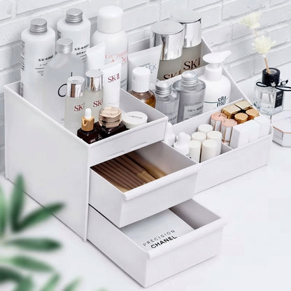 White makeup organizer with open drawers and multiple angled slots for bottles