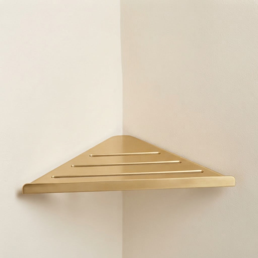Golden stainless steel slatted corner shelf with three bar openings.